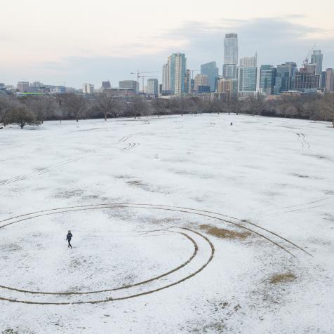 A person walks through a snow covered Zilker Park in Austin, Texas, U.S., on Thursday, Feb. 18, 2021. Texas is restricting the flow of natural gas across state lines in an extraordinary move that some are calling a violation of the U.S. Constitutions commerce clause. Photographer: Thomas Ryan Allison/Bloomberg via Getty Images