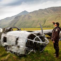 Alaska Maritime National Wildlife Refuge, Aleutian Islands, Alaska: A B-24 bomber, which crashed on Atka Island during World War II.  This is only one of two B-24 bombers to remain in situ since the war. U.S. Fish & Wildlife Service Refuge Chief Steve Delehanty looks toward the sky and flight path the bomber took.