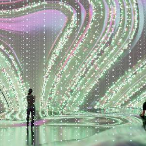 Wavy shapes displayed on a large digital screen in a room. All items in the scene are 3D
